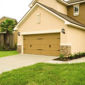 san antonio home with a mustard brown colored carriage style garage door