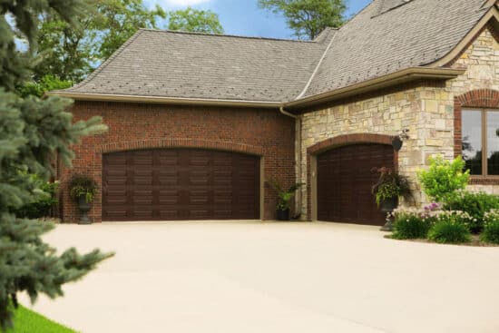 modern home with two large mahogany wayne-dalton 9800, faux wood grain style, fiberglass residential garage doors