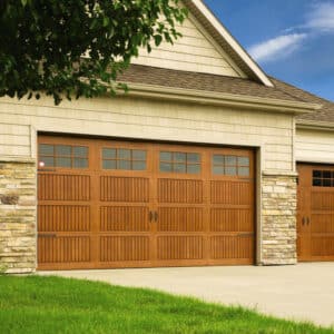 home in san antonio with two cherry colored wayne-dalton 9800, faux wood grain style, fiberglass residential garage doors