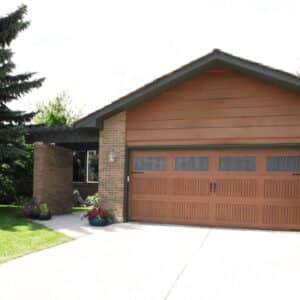 brown wayne-dalton 9800, faux wood grain style, fiberglass residential garage door on a san antonio home