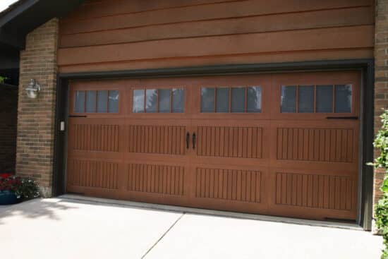 closeup of a dark brown wayne-dalton 9800, faux wood grain style, fiberglass residential garage door