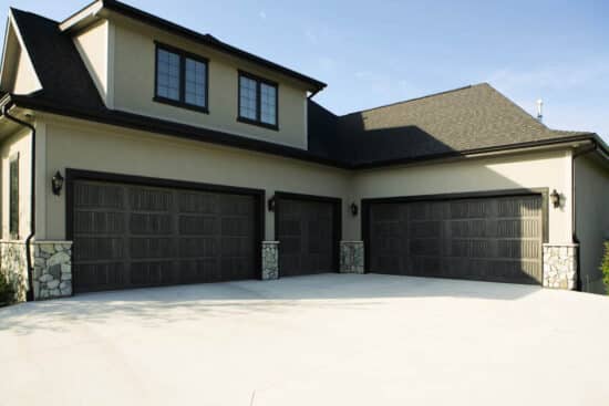 large home in san antonio with three different sized sonoma gray wayne-dalton 9800, faux wood grain style, fiberglass residential garage doors
