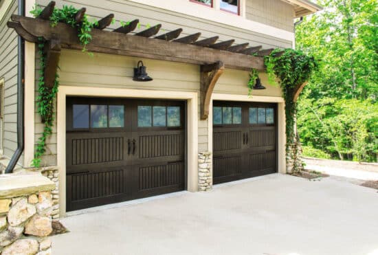 closeup of a home with two sonoma walnut wayne-dalton 9800, faux wood grain style, fiberglass residential garage doors with lite windows