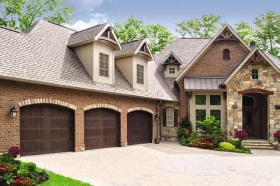 large home with three sonoma walnut finish wayne-dalton 9800, faux wood grain style, fiberglass residential garage doors