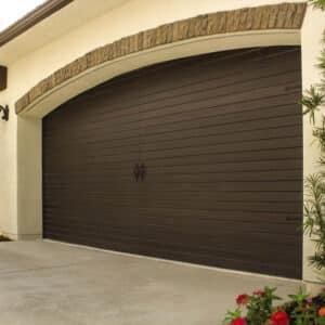 closeup of a dark walnut colored wayne-dalton 9800, faux wood grain style, fiberglass residential garage door