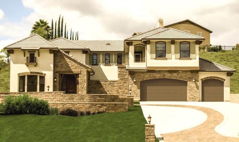 very large modern/stone home with two walnut colored wayne-dalton 9800, faux wood grain style, fiberglass residential garage doors that are different sizes