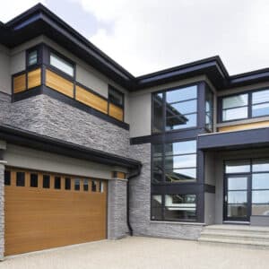 closeup of an ultra modern home with a natural oak vertical window wayne-dalton 9800, faux wood grain style, fiberglass residential garage door