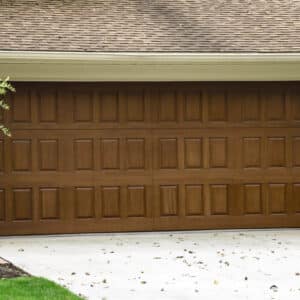 closeup of a home with a natural oak colored wayne-dalton 9800, faux wood grain style, fiberglass residential garage door