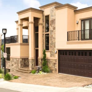 very large home that has a vertical raised mahogany vertical window wayne-dalton 9800, faux wood grain style, fiberglass residential garage door
