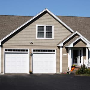 Home with three car white garage and new driveway